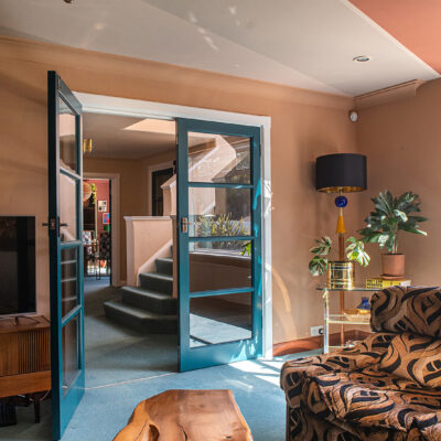 art deco interior with geometric patterned Englander sofa and live edge wooden coffee table